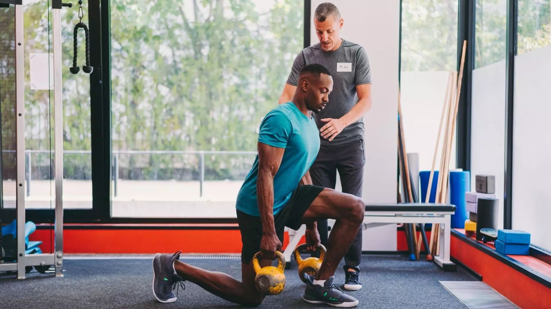 Trainer supporting a member during a session